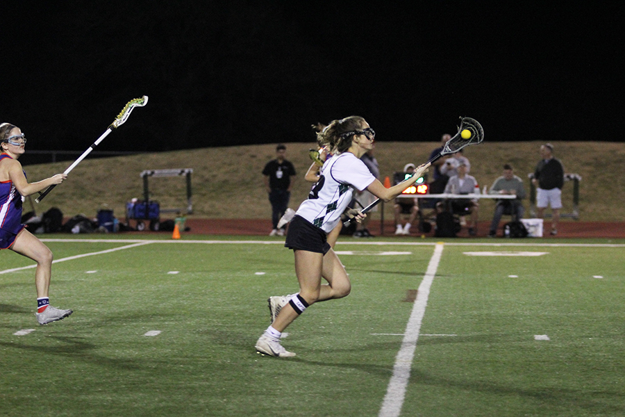 Captain+Rowan+Rodriguez+moves+quickly+to+catch+the+ball+in+her+lacrosse+stick.+The+team+always+puts+100%25+effort+into+the+games+they+play.+%E2%80%9CMost+of+the+time%2C+I%E2%80%99m+really+excited+to+play+and+feel+very+determined+to+do+my+best%2C%E2%80%9D+Rodriguez+said.+%E2%80%9CI+try+to+give+each+game+and+practice+all+my+efforts%2C+which+helps+me+become+more+motivated+throughout+the+season.