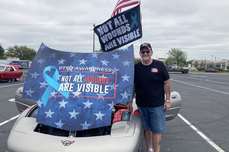Flag+flying+high+in+the+background%2C+Veteran+Rock+Snyder+stands+with+his+vehicle+at+the+cookout.+Snyder+wants+to+spread+awareness+about+PTSD%2C+a+mental+condition+that++he+has+to+overcome.+%E2%80%9CYou+know%2C+reach+out+to+one+person+who+may+have+a+friend+or+a+loved+one+with+this+and+it+saves+their+life%2C%E2%80%9D+Snyder+said.+%E2%80%9CThats+what+Im+here+for.%E2%80%9D