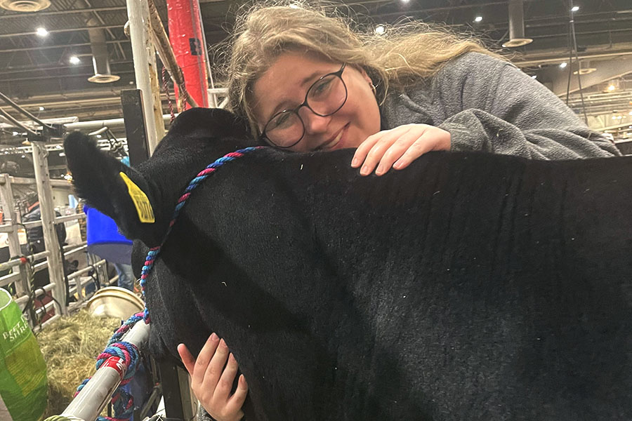 Posing with her steer, senior Emma Janysek smiles at an FFA competition. Janysek has participated in FFA since sophomore year and this was her final year she contributed for the school. “I’d get to the barn, then I’d have to feed my cow and my pig,” Janysek said. “They’re both gone now sadly, but then I went to school and typically, if I had Robotics that day, which I normally did, I’d go to my off period to get Chick-fil-a, come back then have to do Robotics for three hours. Then I’d leave the Robotics team to go back to the barn, feed my steer again, and walk him for thirty minutes. Because you know how you walk a dog? You kind of have to do that with a cow, just to get them used to walking. So when you take him to the show they know how to walk in the ring and don’t freak out. But raising a steer was really cool. Not a lot of people do that and it’s a lot of work. But I think it paid off.”