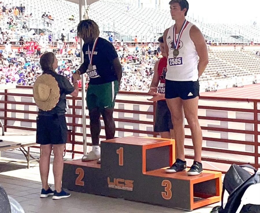 Standing+on+a+podium%2C+senior+Kevin+Adams+receives+a+2nd+place+Track+UIL+State+Championship+medal+for+discus.+Adams+competed+on+May+13+and+threw+a+new+personal+best+in+discus+with+a+throw+of+187+feet+and+4+inches.+%E2%80%9CWith+this+being+my+third+time+at+State%2C+I+knew+what+I+was+going+into+and+knew+where+my+head+needed+to+be+going+into+my+events%2C%E2%80%9D+Adams+said.+%E2%80%9COverall+my+State+experiences+were+fun+and+I%E2%80%99m+going+to+miss+having+another+year+to+try+and+win.%E2%80%9D