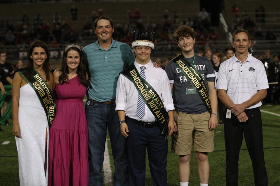 From left to right, senior and second runner-up Audrey Johnson, former Homecoming queen and 2012 alumnus Bailey Kramr, former Homecoming king and 2012 alumnus Cameron Kramr, senior and Homecoming king Carver McDonald, senior and runner-up Ryan Taylor and principal John Sloan pose for a photo at the Homecoming football game.