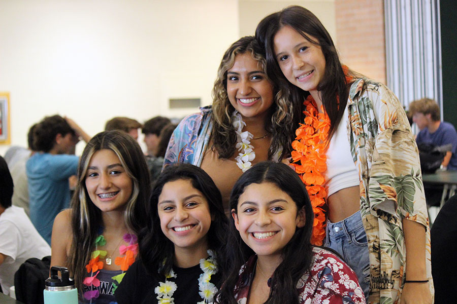Huddled together closely, sophomores Amelie Vielma, Alaina Marsh, Itzel Trejo, Mia Trejo and freshman Kristen Villanueva dress up as surfers for this year’s Homecoming spirit week “Teen Beach Movie” theme. The underclassmen and upperclassmen were assigned different roles to dress up as, with the upperclassmen assigned to dress up as bikers, and the underclassmen as surfers. “Bikers and Surfers was my favorite day,” Marsh said. “I wanted to go all out and represent my grade. This day was so fun getting to see all my friends and classmates dressing as surfers with their leis and Hawaiian shirts.” 