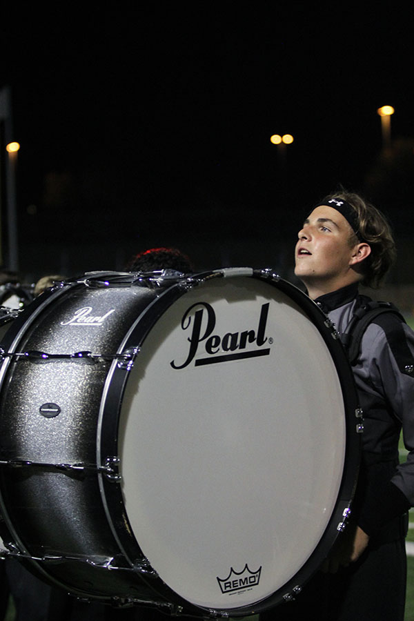 Staring up at the bleachers crowded with people, sophomore Alex Foster performs with the drumline. For the second year in a row, Foster played with the band during the homecoming game against East View. The reason I am in the band is that I just love to play drums, Foster said. I also cherish the relationships I have built with all of the members of the organization, no matter the seniority or the instrument they play.