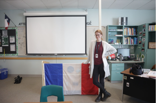 Posing in front of the French flag, new French teacher Naomi Campbell is the newest teacher in the department and sponsor of the French Honor Society.  While being a small community of just under 100 students, the language is connected by passionate students both in the class and in FHS, as well as being an equally important language to learn. “Its the third most spoken language in the world, Campbell said. “Its used in business a lot of the time. So its very useful for international commerce. And its an official language of the UN. Its the official language of the Olympics.”