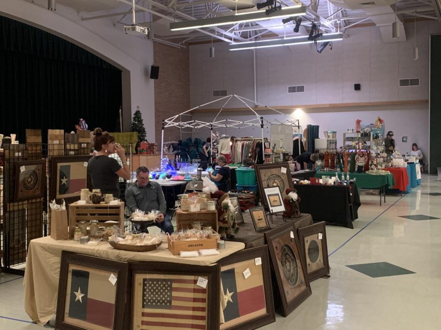 A woodworking vendor shows off his creations at the annual Project Graduation Holiday Bazaar on Dec. 10. “We’ve been doing this since 2012, and so some of the vendors have actually reached out to us,” Project Graduation president Paula Hufford said. “A lot of them have been here year after year, [but] some of them are new. Some of them are [current] students or previous students, so theyre familiar with the event, and now they’ve started their own little businesses.”