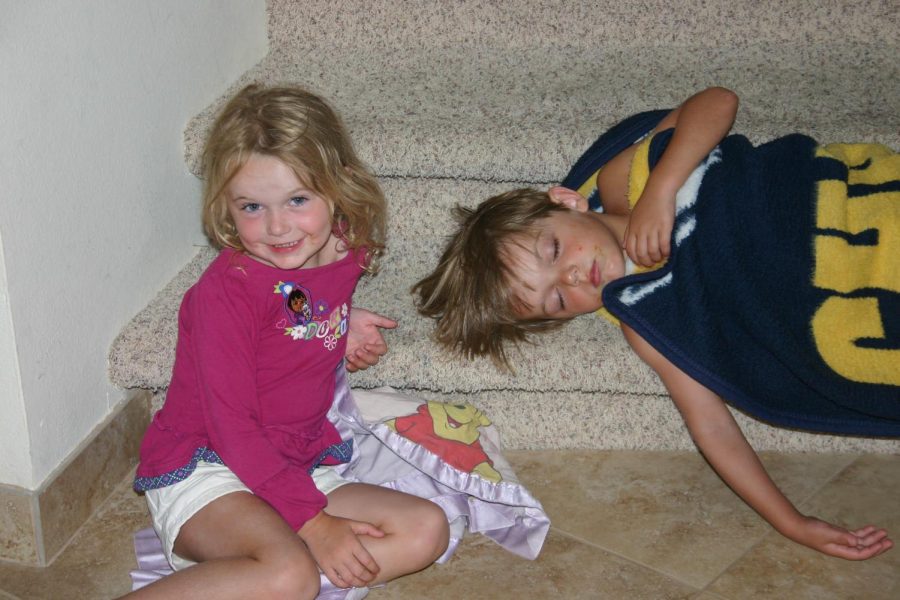 Posing at the bottom of our staircase, I smile at the camera in late June of 2010 as Harrison decides that the first step of the stairs is a good place for beauty sleep. Here I was four and Harrison was five years old, and the red stuff on our faces was some ribs that we had just eaten. Well, more like smeared on our faces.
