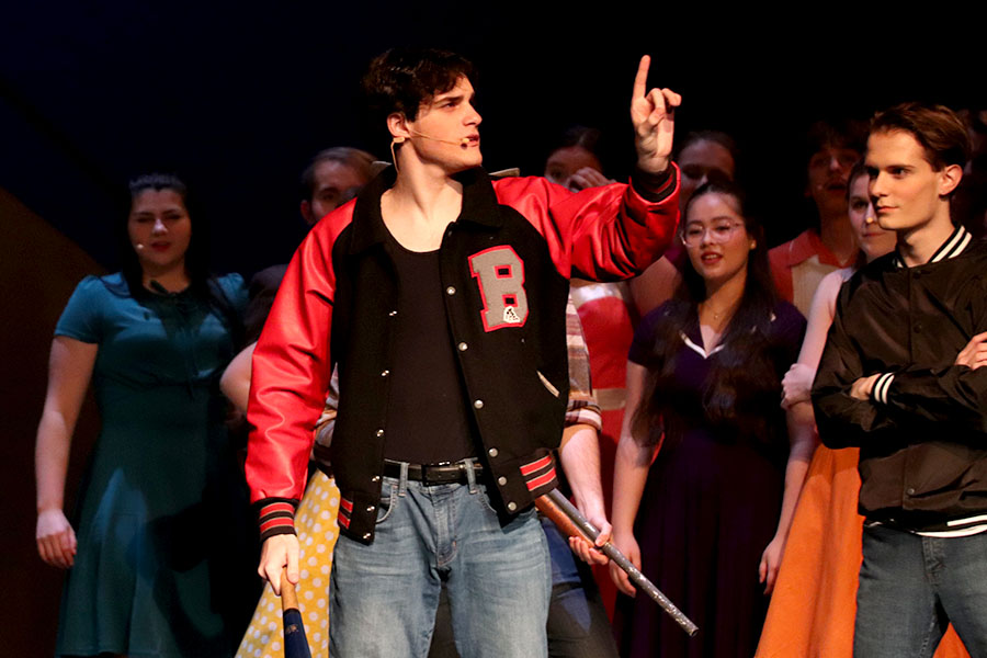 Performing as the high school bully in “Big Fish,” senior Aidan Johnson yields his baseball bat while defending his small village. This scene required Johnson to protect his village from a giant, played by sophomore Evan Schmitt. “We put the show together very quickly,” Johnson said. “We didn’t have a ton of time and it came together really well. It was a fun character to figure out. It wasn’t as deep of a character as other ones I’ve played, but since it was such a simple character, I was able to convey it a lot better.”