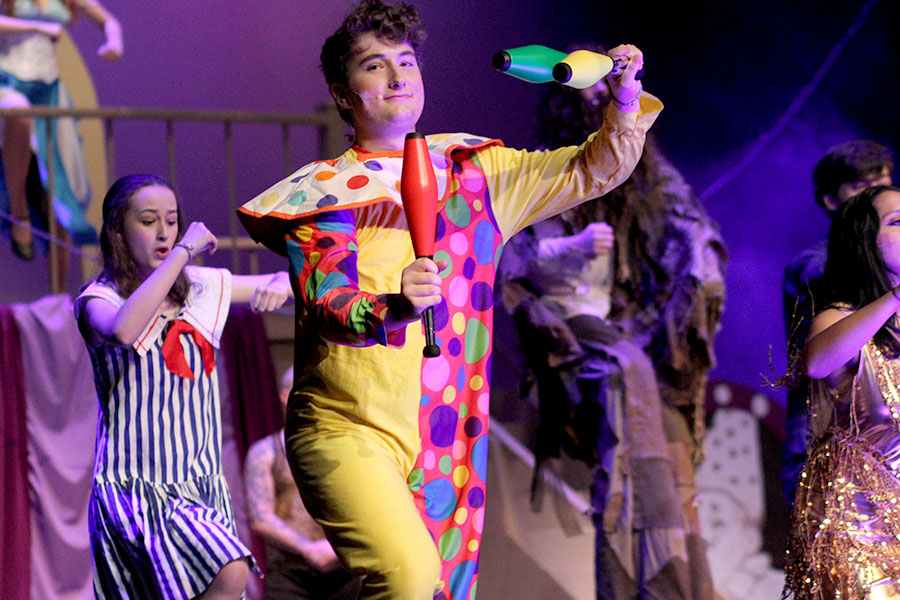 Juggling pins in the air, senior Ryan Taylor waltzes across the stage as he performs the number, “Closer to Her” in the Theatres production of “Big Fish.” In the musical, Taylor played a clown character. “In this scene, I am auditioning to be a part of Amos’ Circus,” Taylor said. “I’m attempting to juggle to impress everyone there, but I can’t actually juggle, which is quite a problem. Overall, ‘Big Fish’ was really awesome and was a lot better than previous years because we got a full run in before tech week.”