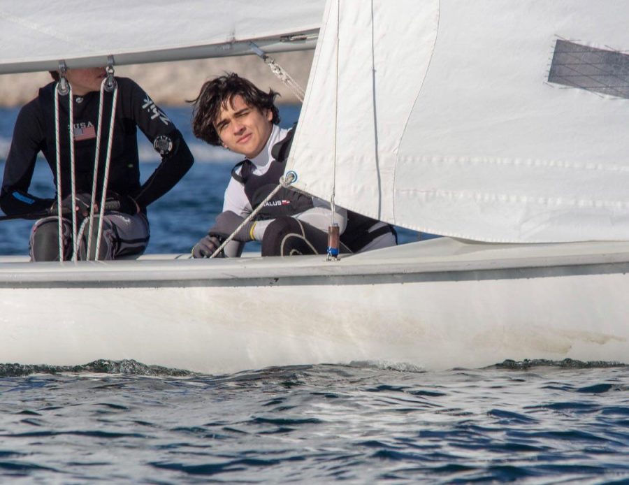 Senior Julian Rabago looks out from his sailboat, with his close friend, senior Lucas Tenrreiro behind him. Rabago said his friendships are of the utmost importance to him, which is a reason he joined sailing in the first place. “One of my best friends sails, and in high school I wanted to do a sport, so I chose sailing,” Rabago said.
