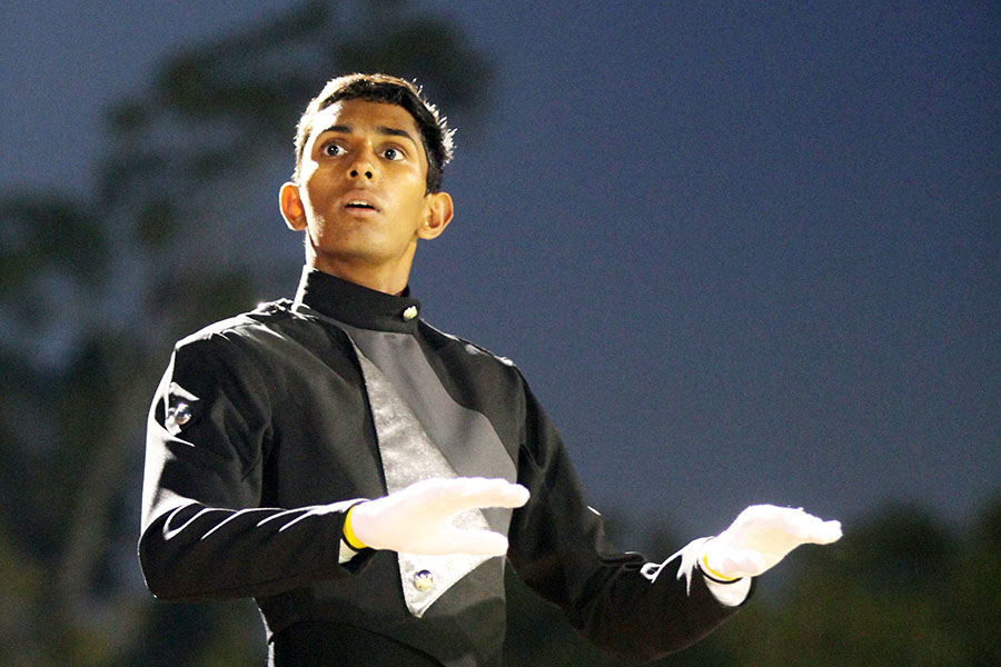 With his arms high, senior Arnav Batra counts of the band at halftime at the homecoming game. Batra has been in band since middle school, becoming a drum major this year.  “Its really fun to be able to go to all the football games and go to all the competitions,” Batra said. “Just knowing that for that one day or for those two days in a row, your life is just taken up by one specific thing and youre just around like these 250 people that know you know and you know what you need to do to be the best.”
(Photo by Arav Neroth)