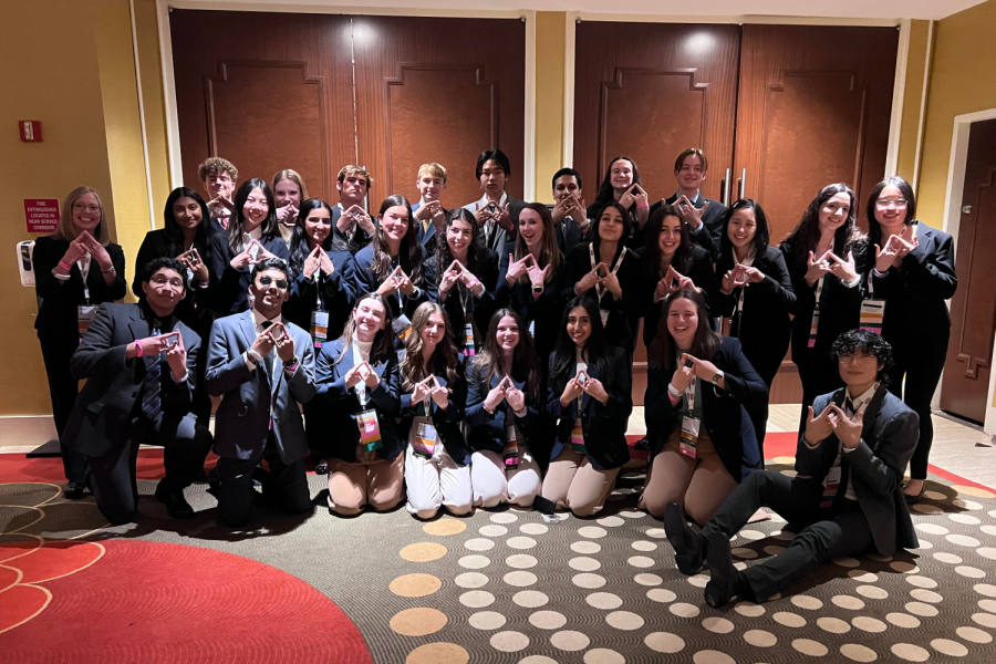 Holding up the DECA Diamond hand symbol, DECA advisor Kimberly Stapleton poses with all of her students at the Texas Collegiate DECA State Conference in March. At the competition, seven of her students advanced to the International Career Development Conference, including seniors and eventual national champions Ethne Barnes, Paisley Schalles and Claire Poulter. “We have done integrated marketing campaigns for the past three years,” Barnes said. “Weve gone to ICDC in all three of them, but this year we placed first in the whole thing, so its kind of surreal. Its kind of crazy that weve been doing it for three years and last year we didnt even place in finals, and now this year we were literally first in the world.” (Photo Courtesy of Kimberly Stapleton)