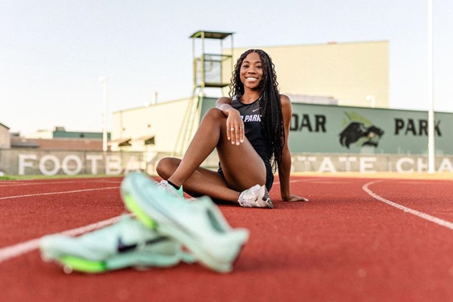Sitting+and+smiling%2C+Amani+Graham+takes+her+senior+pictures+on+the+Cedar+Park+High+School+track.+Graham+said+that+she+has+always+wanted+to+pursue+track+as+a+college+career+and+SFA+is+the+perfect+place+for+her.+%E2%80%9CI+fell+in+love+with+SFA%2C+Graham+said.+%E2%80%9DThe+campus+immediately+felt+like+home.+It+was+a+place+I+could+see+myself+growing+not+only+as+an+athlete+but+an+individual+as+well%2C+and+I+am+really+excited+to+start+there+next+fall.%E2%80%9D%0A%28Photo+Courtesy+of+Amani+Graham%29