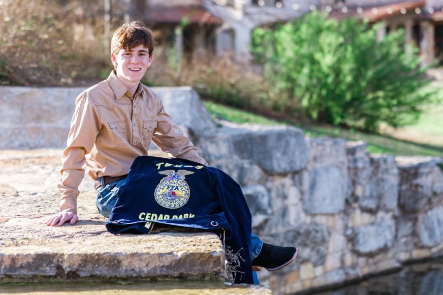 With his FFA blue corduroy jacket draped over his lap, Cedar Park FFA Chapter President Jackson Cox poses for his senior pictures. Cox will attend Stephen F. Austin State University this fall to study forestry with a concentration of wildlife to pursue a career as a game warden. “I like the position that game wardens have in the community as positive influences,” Cox said. “[They] lead people away from [making] bad decisions, promote conservation, and protect natural resources. I [want] to be a faithful steward of all that were entrusted with by God and take care of the natural resources [He] has entrusted us with, [as well as] motivate others to take care of it.” (Photo courtesy of Jackson Cox)