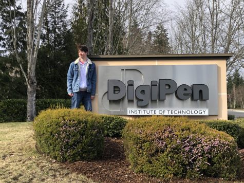 Standing in front of the DigiPen Institute of Technology sign in Redmond, Washington, senior Simon Moss visits the college campus on a trip to Seattle. While visiting the school, Moss got to see what different programs DigiPen offers more in depth and meet new people. “[DigiPen] is going to be great because everyone that was accepted got invited to a discord [server] and everyone has been able to talk to each other and get to know everyone,” Moss said. “I don’t want to be in a campus where they have too many fields and people have different interests, but here everyone is very like minded.” (Photo courtesy of Simon Moss)