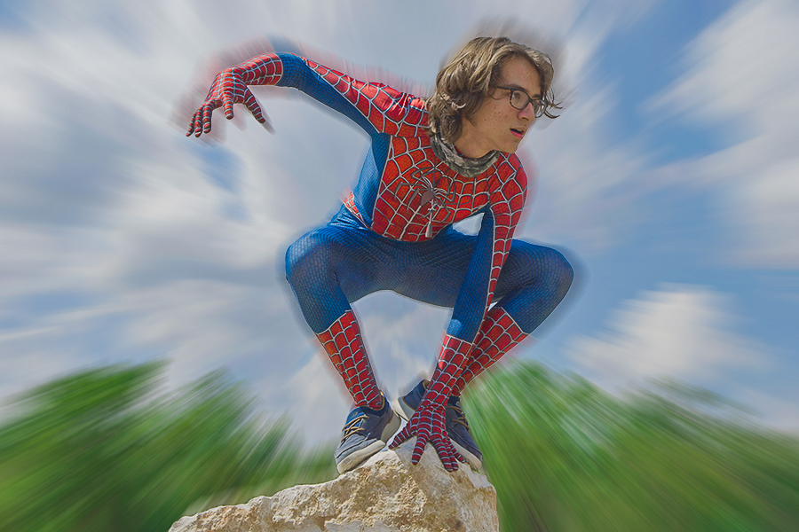 Wearing a Spider-Man suit, sophomore Ben Akers poses on top of a rock. “I’m just Im truly fascinated by his story because, like, hes just this teenager dude, and then he gets bitten by a spider and then a ton of bad stuff happens to him, but he just keeps trucking along and keeps being a good person,” Akers said. “I have a Spider-Man suit and it was kind of a joke at first, but now its not really a joke. I just am Spider-Man.”