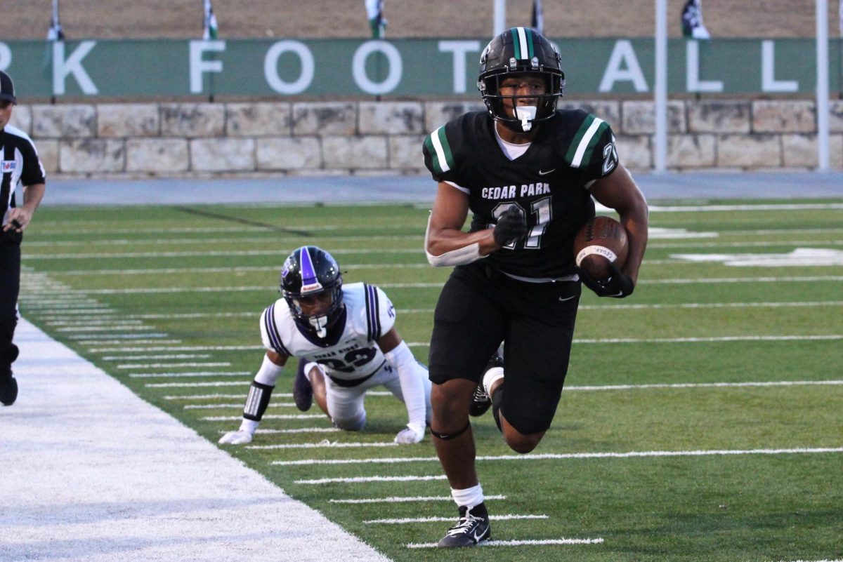 Leaving his opponent on the ground after a quick and precise maneuver, sophomore running back Trae Hill sprints toward the end zone. The varsity football team will play against Round Rock High School tonight at 7:30 p.m. at Gupton Stadium. “[Being on varsity] made me work a lot harder,” Hill said. “It’s a lot more mental, [too]. People don’t understand that if you’re not in the right headspace, then you won’t be at your best. I hope we make a lot of memories [this season]. We’re confident and we practice hard for sure. We realize that we have a good team this year, [that] we have potential.” 