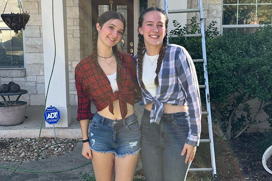 Dressed like cowgirls, juniors Margo Bonavitacola and Brooke Ferguson pose for a photo before a country versus country club football game. Bonavitacola is an exchange student from France that Ferguson’s family is hosting this year. “My first football game was really a dream because it’s really an American thing and everyone in France is dreaming about that,” Bonavitacola said. “It’s so cool [and] I love it so much. I just enjoy the things that are really normal because it’s different and it’s not the same culture so I enjoy it.”
 
