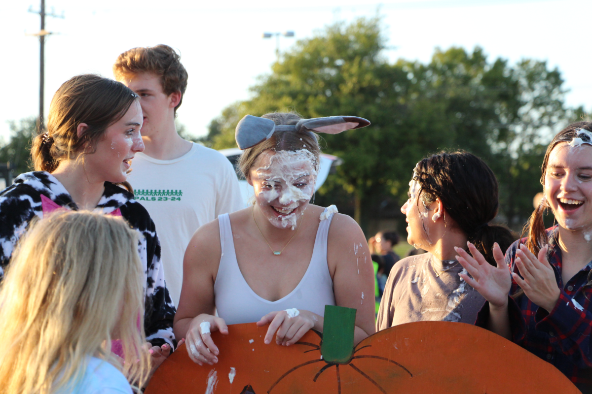 Dressed as a cow, PALs member and junior Lynnea Bergman smiles at her friends with a face covered in whipped cream. The annual trunk or treat took place on Oct. 26 during which the PALs pie in the face activity was very popular, according to Bergman. “We were doing a pie in the face and cakewalk to get the kids to have fun,” Bergman said. “Some of the kids in the PALs [program were at the trunk or treat] and they got to pie us in the face. [My favorite memory] so far is probably getting pied in the face by a four year old. He went so hard and it was very funny.”
