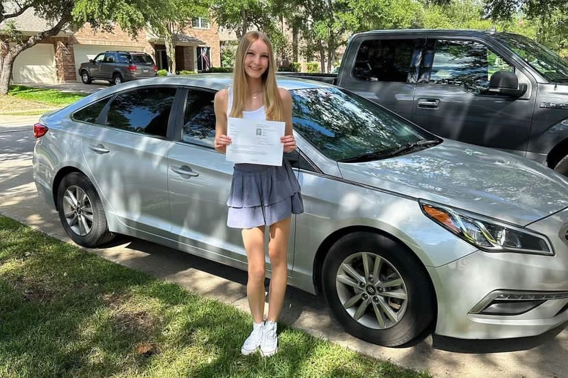 Posing next to her 2015 Hyundai Sonata, junior and Celebrities Dance Team Second Lieutenant Sophie Poulsen holds up her license. Poulsen’s car was stolen on Aug. 28 from the school parking lot, and was missing for a day before police recovered it. “I was shocked,” Poulsen said. “I never expected, especially in Cedar Park, for my car to get stolen. I still don’t know who [stole my car], but I wish I knew. I don’t think the cops are going to figure it out, because there’s no point. It already happened. We’re probably never going to know. I feel like it was a student, but who knows? [Nevertheless], Cedar Park is not that [kind of place].”