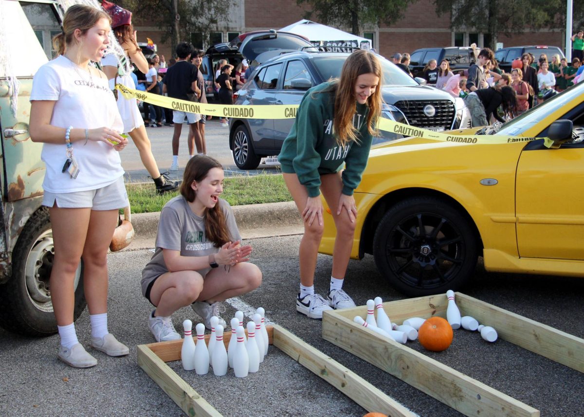 As the little trunk-or-treaters step up to play, the cross-country team cheers them on and presents the winners with candy. At the trunk or treat, participants put their pumpkin bowling skills to the test while sophomore Annie Gohean and others led the game. “It was fun to help the kids and to see them try to knock down the pins,” Gohean said. “Helping the elementary school kids was definitely my favorite part of working the booth.”