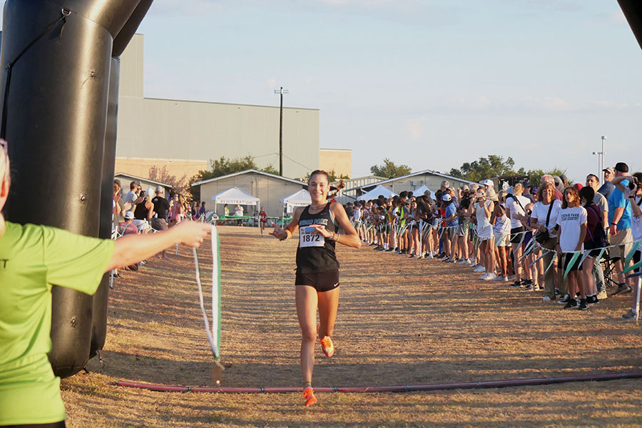 Crossing the finish line, senior Isabel Conde De Frankenberg secures first place at the Cedar Park invitational on Sept.9. This was Conde De Frankenberg’s first race of the season and she has won this race every year since she was a freshman. “Winning felt good because it’s good to represent your school,” Conde De Frankenberg said. “Being able to run on your own campus is really exciting and I had fun.”
