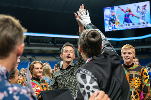 High-fiving a band member in the Alamodome in San Antonio, Head Director of Bands Christopher Yee celebrates the band’s fifth UIL state win with his students. The band faced several challenges this marching season due to the difficult show routine, but was able to come in first at the state contest. “Every year is different,” Yee said. “The show is different, the kids are different, the challenges are different and the competition is different. This [year] feels a little more special. Theyre all special, but this one is particularly special because it was so hard fought. Weve mentioned several times to the kids that they seem like theyre one of the happiest bands weve ever taught. Theyre just happy kids. This years student leadership team [also] stepped up more than normal. I think that theyre very talented. Because it was a hard show, they have a lot of skills and a lot of determination and grit.” Photo courtesy of Leander ISD, used with permission