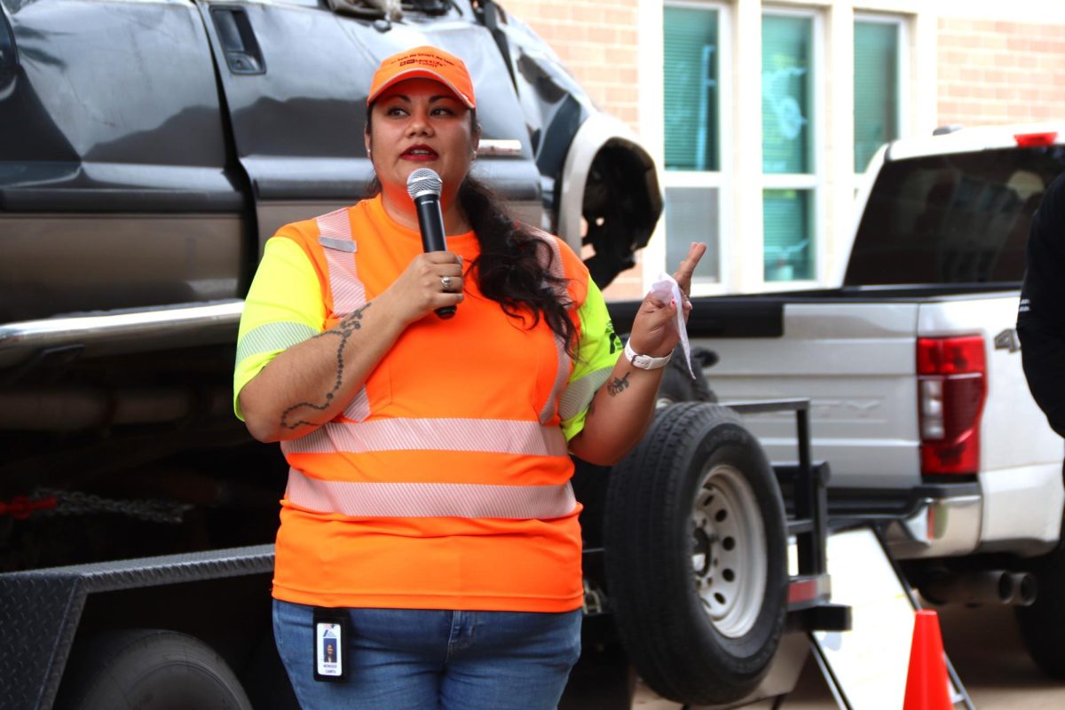 Standing in front of a truck from a teen car-accident, TxDOT Traffic Safety Specialist Monique Campa speaks to students about seatbelt safety on Feb. 8. As a part of the Teen Click It or Ticket campaign, Campa travels the state to give presentations on traffic safety. “Were here to remind everybody to be safe, and how simple it is to put on your seatbelt to save your life,” Campa said. “And its not only your life, but also reminding your friends. Its really important to wear a seatbelt. Everybody, every rider, every time.”