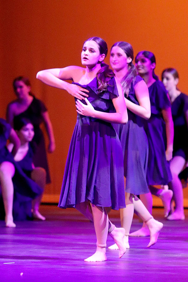 In a flowing dress, freshman Tia Mittra, who is a member of dance team prep, performs “New Years Day” by Taylor Swift during the Holiday Show on Dec. 7. Mittra had auditioned for Celebrities the week prior and had just found out she made the team for the 2024-2025 school year. “I have done winter shows in past years, but it just felt way different knowing that I was going to be on the team and I would be doing all the dances I saw,” Mittra said. “I knew I was going to be way more involved, so I felt really excited.” Photo Courtesy of Lilly Adams, Tracks Yearbook Staff