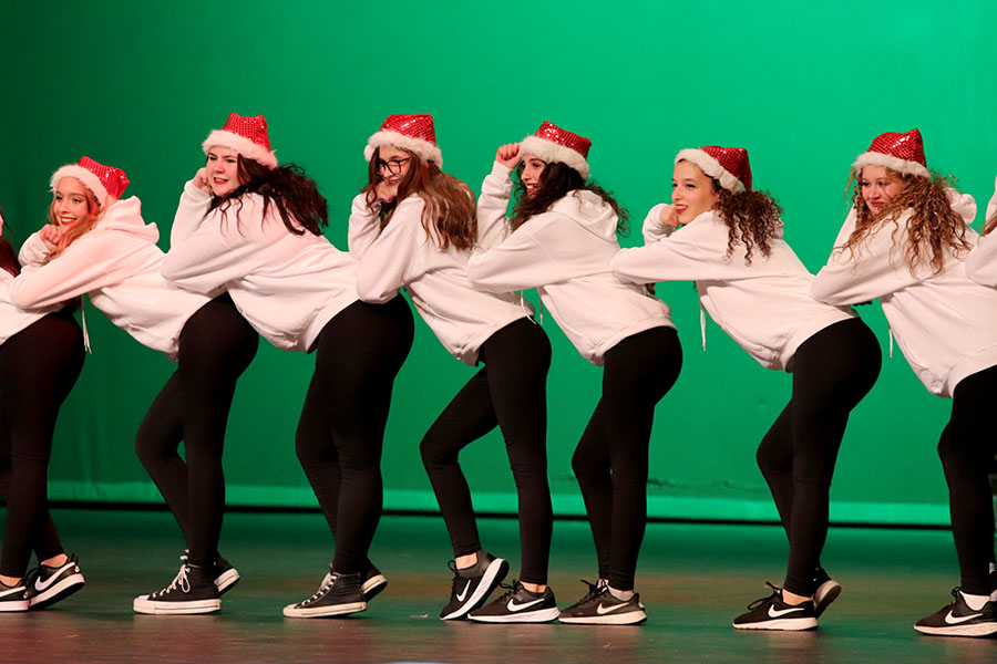 Wearing a red Santa hat, junior Shai Lerner performs with the Luminaries dance team. At the Holiday Show, the Luminaries performed “I Believe in Santa,” which is a mix of hip-hop and jazz. “It was really fun performing in front of an audience,” Lerner said. “I love my team and I love being a part of a team and I like performing with everyone.” Photo courtesy of Lilly Adams, Tracks Yearbook Staff