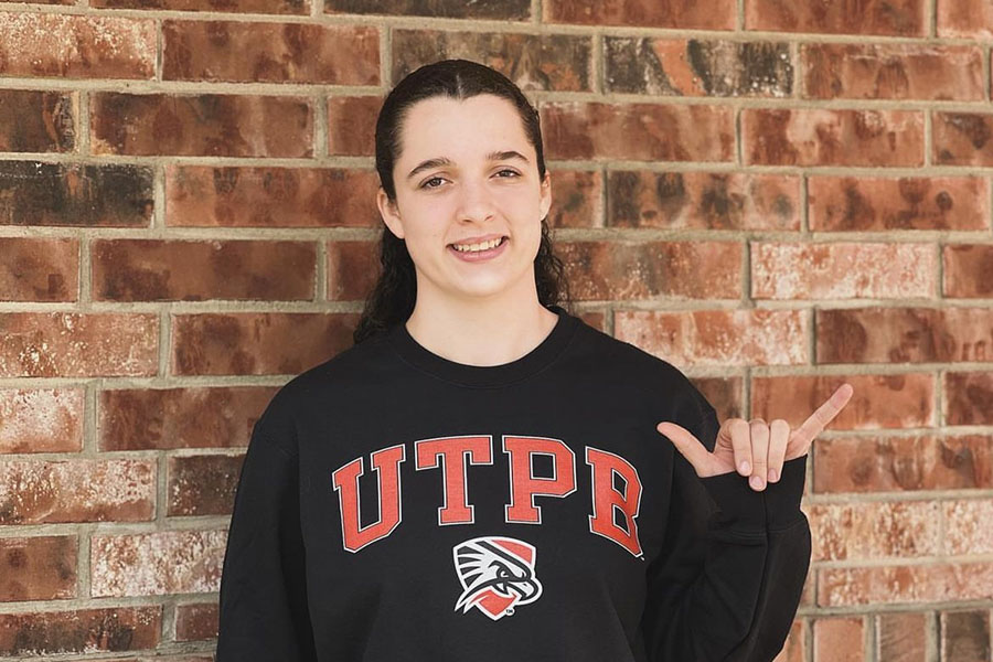 Holding the “Falcons Up” hand sign, junior Alivia Robinson poses in her commitment announcement to the University of Texas Permian Basin (UTPB). She committed to UTPB for softball and wants to continue her academic career. “UTPB is my fit,” Robinson said. “Their team made me feel so welcome and loved. I knew I was going to live being a Falcon. Falcons up!” 
Photo courtesy of Alivia Robinson

