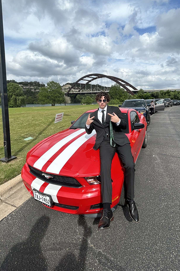 Senior Andrew Giguere strikes a pose with his car before prom in April. Giguere said he’s proud of his car after saving money for a year. “I really like the way it looks,” Giguere said. “I looked at a lot of cars before buying this one, but the Mustang was my best bet.” Photo Courtesy of Andrew Giguere