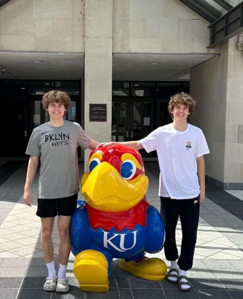 Smiling for a picture, senior identical twins Ethan and Drew OConnor pose with a statue of a parrot mascot. The twins will both attend the University of Arkansas in the fall and major in business. “I didnt really mind going to different colleges, but we had the same [college] choices,” Ethan said. “We both liked Arkansas, and I dont mind him coming with me. If we cant get [a] rooming situation down, were just going to do a quad together. Which Im kind of down for a quad, because there is more room.” Photo courtesy of Drew O’Connor