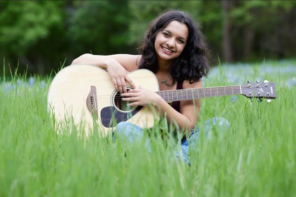 Smiling with her guitar, senior Ishani Pandey poses for a senior photo in a field of wildflowers. Pandey plans to major in Biochemistry on a Pre-Med track at Texas A&M University. “I’m looking forward to putting all my preparation into practice,” Pandey said. “From here on, I’m largely depending on the skills in medicine and academia that I’ve built in high school to hit the ground running in college, and I’m excited for the independence that prospect comes with and the opportunities that might bring in the future.” Photo courtesy of Danielle Walker
