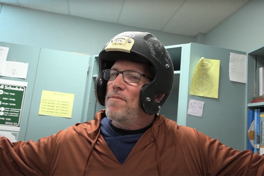 WHAP Teacher and Glorious State Leader Mr. Peterson wears a helmet for protection. “It's not hard in this particular game to get students to turn on each other, in order to gain rewards or gain favor within a state setting, to not want to get in trouble.” Peterson said. “We do hold trials. I try to keep them not all crazy [or] fear based, but it is a little bit anxiety and fear produced when you're sitting in front of the classroom and the lights are out. When you start to remove faces from people, and identities, neutral identities, it's really easy to create hate around specific ideologies and groups of people."