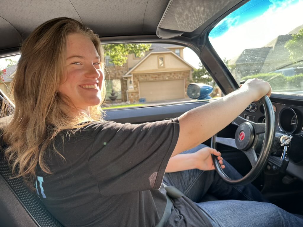 Smiling with her hands on the wheel in her Camaro z28, senior Brooklyn Collinsworth savors these short moments until the car returns back to the shop. “I knew there would be work to be done, but there were too many problems with the engine in the car that they didn't address originally,” Collinsworth said.  “The more [SW] takes it apart, the more they realize the issues with it, but I want to keep that car forever so I'm willing to deal with that stuff so I can have a better experience later.” Photo Courtesy of Brooklyn Collinsworth