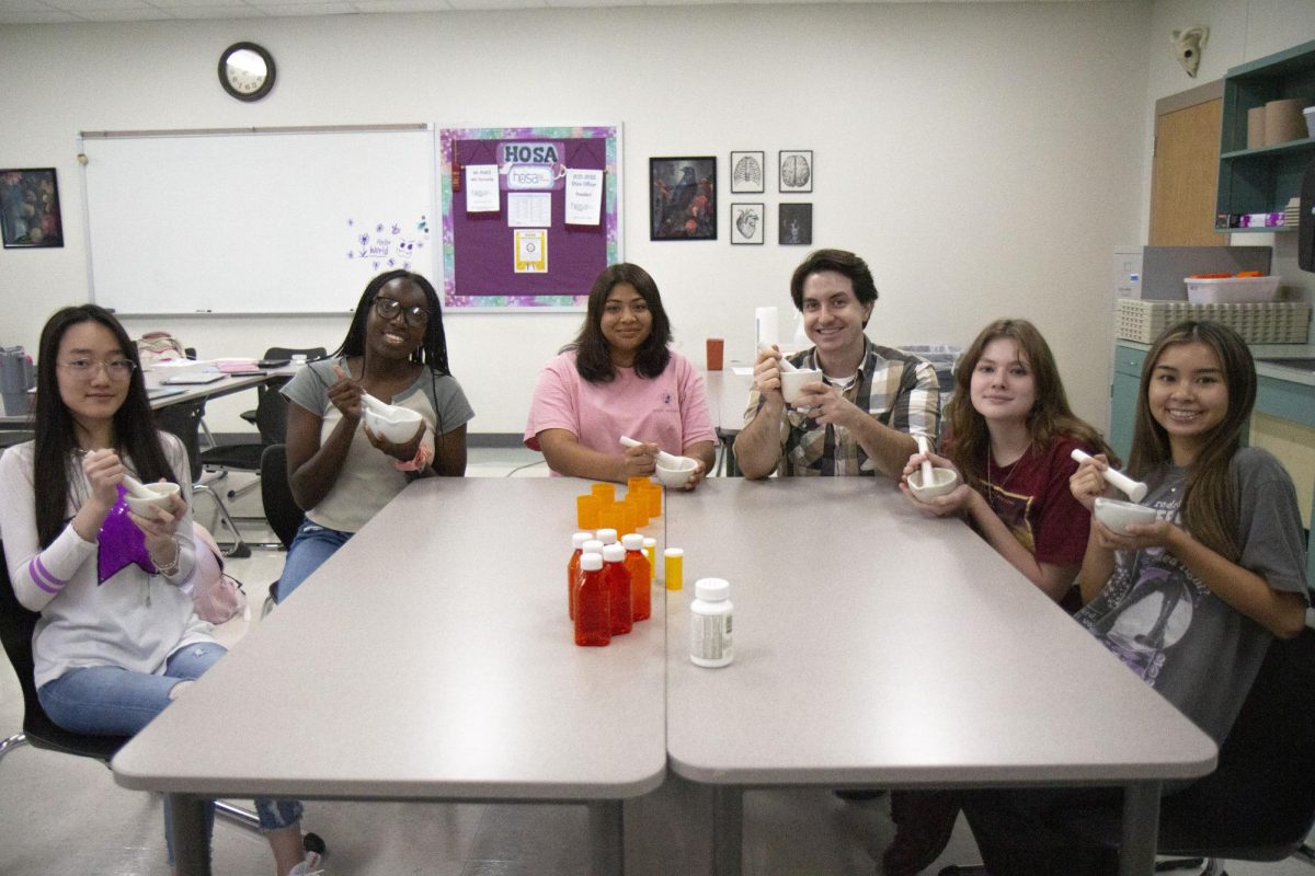 Displaying her mortar and pestle with a freshly ground Tylenol pill, senior Kim Dao smiles with her four other classmates after listening to Pharmacy Technician teacher Tyler Terry inform them on how to prepare medicine. In addition to these materials, Pharm Tech students also learn to use to needles, syringes and molds to practice their skills. “We have only five girls in the class, so you’re more engaged in the class, and you get so close to everyone,” Dao said. “Even though we didn’t really know each other in the beginning, we’re a lot closer now and we like to joke around.”
Photo courtesy of Kaydence Wilkinson