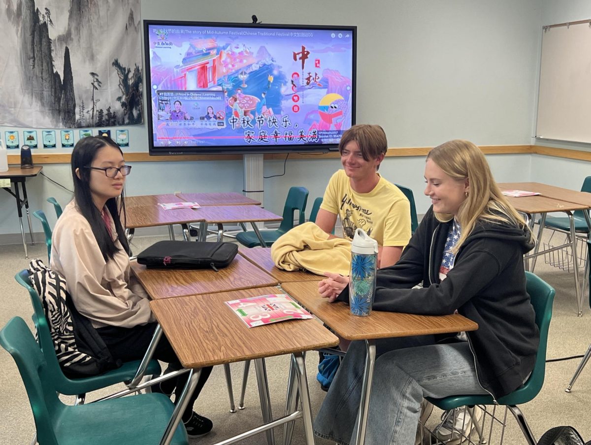 AP Chinese seniors, Carter Peterson,  Ashley Blair and Yushan Pan learn and immerse themselves in the culture by trying Mooncake while in class on Sept. 27. Thanks to a small group of students, the AP class was added to the course catalog this year. “I'm hoping more people would like to qualify and be interested in taking the challenge,” teacher Joyce Chen said. “I also hope that we have more students interested in continuing learning in later classes so they can learn more classical Chinese literature and even current events.” Photo by Kasandra Reynoso
