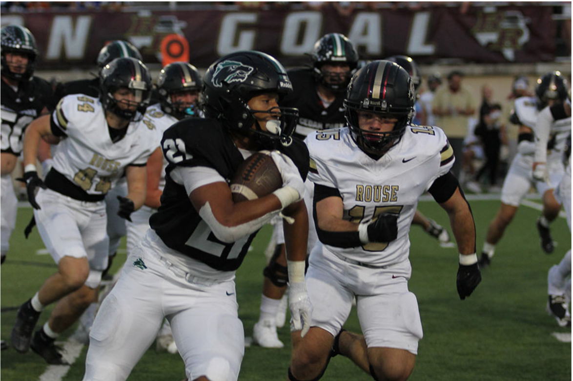 Clutching the football, running back Trae Hill runs the ball past defenders. Hill broke free for a 50-yard touchdown at the homecoming game on October 4. “I think it sparked us,” Hill said. “I feel like it gave us motivation, and it felt great.”