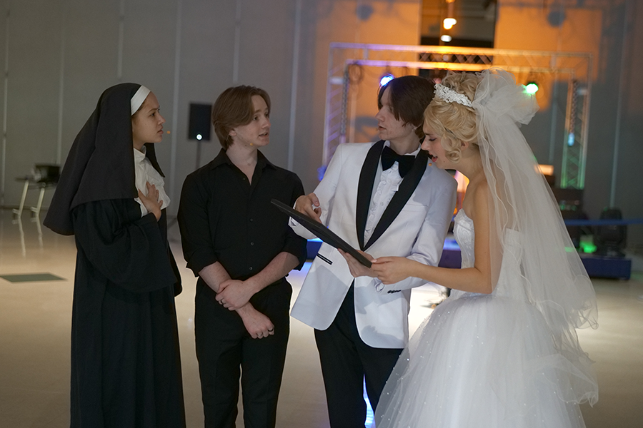 Junior Sasha Ruteledge (right), and seniors Evan Schmitt, Seth Loudenslager, and Kaitlyn Moore gather around a photo of the Pope. Tony and Tina's Wedding is a loosely scripted long-form improv show, that takes place in the late 70's. "I think I always have something to say to someone, when I'm in character," Loudenslager said. "I always have a line that I can just improv, but I think sometimes it could be really hard to be able to place yourself physically in a place that you should be while a certain scene is going on. Sometimes you're not supposed to see a certain scene, sometimes you either forget about it, or you don't know. You have to be really careful about that.  I find that to be kind of hard and tricky at times"