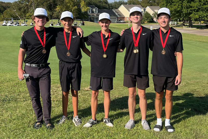 Standing proud, varsity senior athletes Rafael Escobar, Griffin Jacobs, Jakob Martin, and juniors Jackson Springer and Jack Morris pose with their newly earned medals. The varsity team finished third out of 14 teams on Sept. 25. “The team's primary goal is to win the district championship,” head coach Cody Price said. "We're confident that with our action plan in place, we can accomplish this mission. [For the next tournament], our preparation involves assessing our strengths and weaknesses, celebrating milestones and creating individual development plans." Photo courtesy of Cody Price