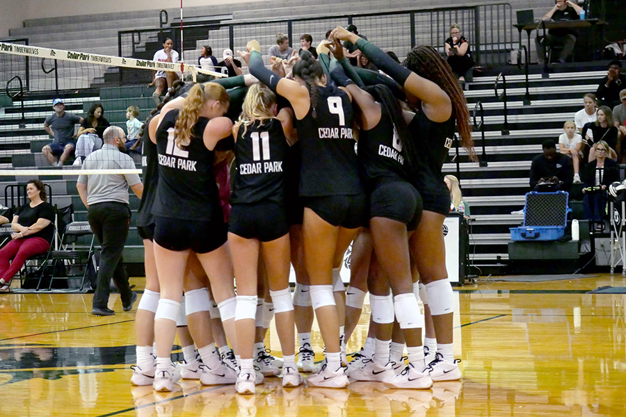 With their T-Wolves held high, the varsity volleyball team huddles together in preparation at a match in early September. The team is 6-0 in match play and will start the second round of district play next week. “The second time isn’t going to be easy,” Head Coach Lori McLaughlin said. “That's the thing about this district. The coaches are so good and very skilled with what they do and every team is usually different the second time that we play. We just want to hope that we add some more finesse to our game, and then lead us into the postseason, which hopefully [has us] peaking at the right time.” Photo by Julia Seiden