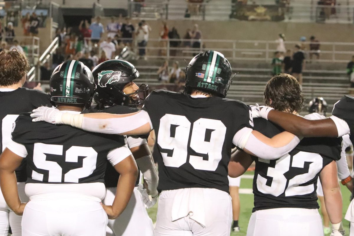 Putting his arms around his teammates at the end of the Homecoming game against Rouse High School, junior Brooks Bouffard faces Rouse’s band as they play their school song. Brooks is a varsity defensive lineman and has a close bond with players from several position groups. “I am close with many of my teammates; we get along great and hang outside of practice together,” Bouffard said. “After games we go out to eat or do stuff like watch other football games. Our friendship has definitely grown, especially after these past two years because of football, seeing each other everyday and being with one another.” Photo by Addie LoSurdo