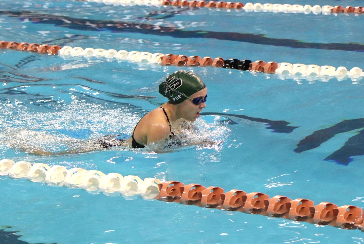 Sucking in a breath of air, freshman Lily Pope competes in the 200 yard individual medley. On Oct. 25, the swim team competed in the AISD Swim Invitational. Overall, the girls team took second place and the boys team came in eleventh. “My favorite stroke is butterfly because I do the best in that stroke,” Pope said. “I feel like [butterfly] can test how [your ability] to convince yourself to keep going. The hardest part of swimming is convincing yourself to stay strong and keep pushing during a hard race [when] everything is tired.”