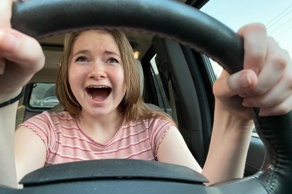 Wearing a nervous look while sitting behind the wheel, sophomore Elizabeth Miller works on getting comfortable in the driver's seat. Although she doesn't have her permit yet, Miller is working to get one through Aceable, an online driver's education course. “I’ll learn to drive eventually because I want to be able to get myself places instead of having to depend on others,” Miller said. “It would be really cool to drive because then I could have more ‘me time’ and I could drive my friends and I wherever we want to go.”