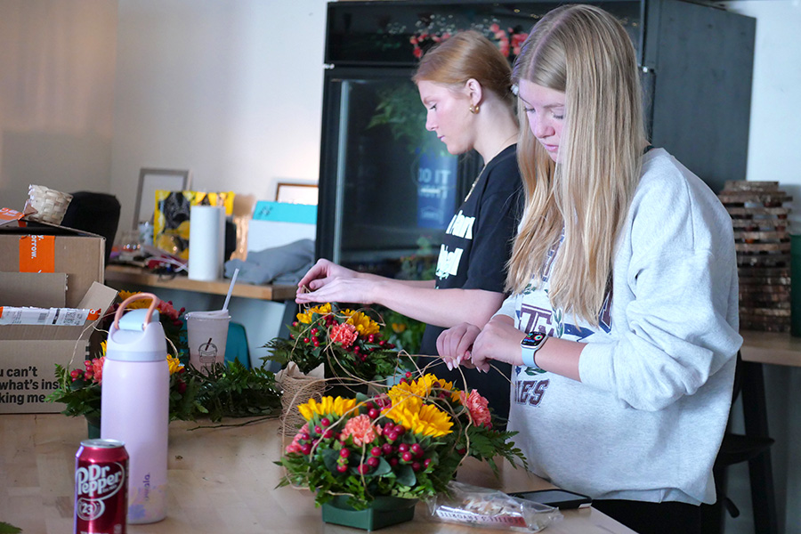 Delicately placing the string to form the shape of a cornucopia, seniors Haley Burton and Avery Nelson create the November arrangement for the Flower of the Month Club. This club is led by Advanced Floral Design Students and provides a monthly arrangement to community members who subscribe to receive them. “I think flower of the month club is a really impactful way to show your loved ones ‘hey I really care about you,’ or even if they’re just for yourself, they’re a little pick-me-up throughout the month that [say] ‘I’m doing ok, and these flowers make my day a little bit brighter,” Nelson said. “I like giving people flowers because people value the flowers more and they value themselves more.”