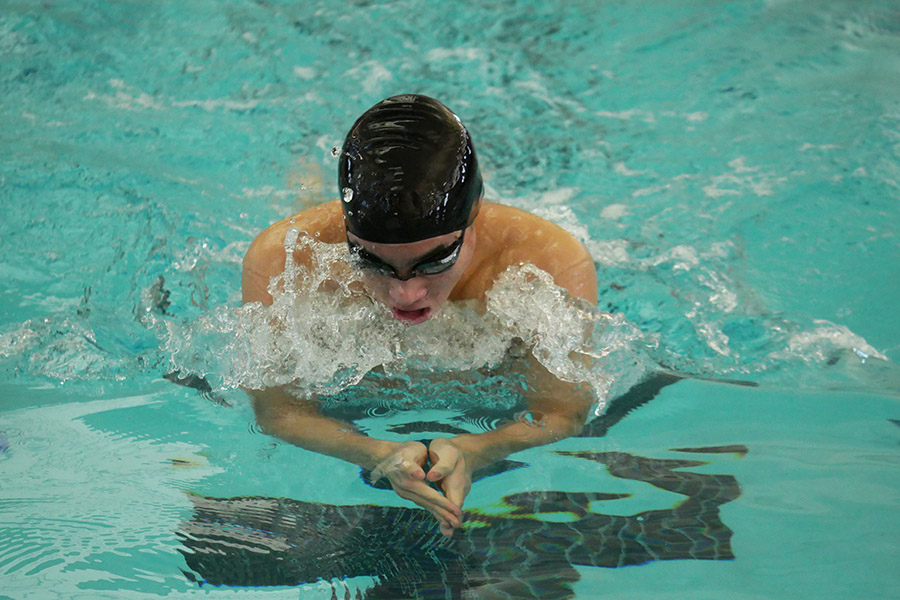 Taking a breath, senior Parker Huang cuts through the water while swimming the 100 breaststroke at the district meet on Jan. 23. Huang advanced to the regional meet in the 100 fly, 100 breast and 200 medley relay. “It’s been really exciting to see everyone make it [to regionals],” Huang said. “There’s been a lot more people who have been advancing than last year, so it’s really awesome to see that.”
Photo by Skyler King