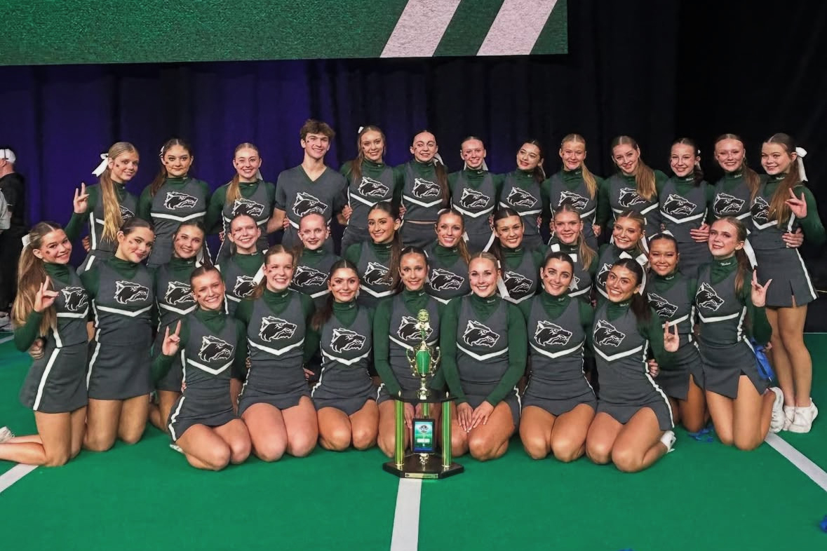 Posing with their trophy, the varsity cheer team takes a picture following their sixth place performance at the Universal Cheerleading Associtation’s National High School Cheerleading Competition. This was the highest the team has placed in school history. “[Breaking the record] is like more than I could ask for, so I’m really proud of them,” Head Cheer Coach Nadira King said. “It’s so exciting because now they have the confidence and they’ve had a little taste of something good. I think that will be good for our future as a program.” Photo Courtesy of CPHS Cheer