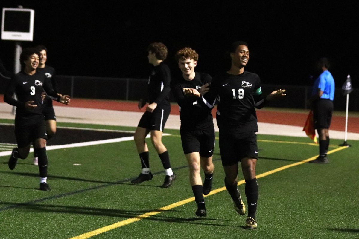 Celebrating a goal, senior defender and captain William Gray poses for the camera. The team finished second in district with a 9-2-3 record. “I am, of course, very proud of this team,” Gray said. “But, we aren’t satisfied. We want to keep winning and go as far as we know we can in the playoffs.”