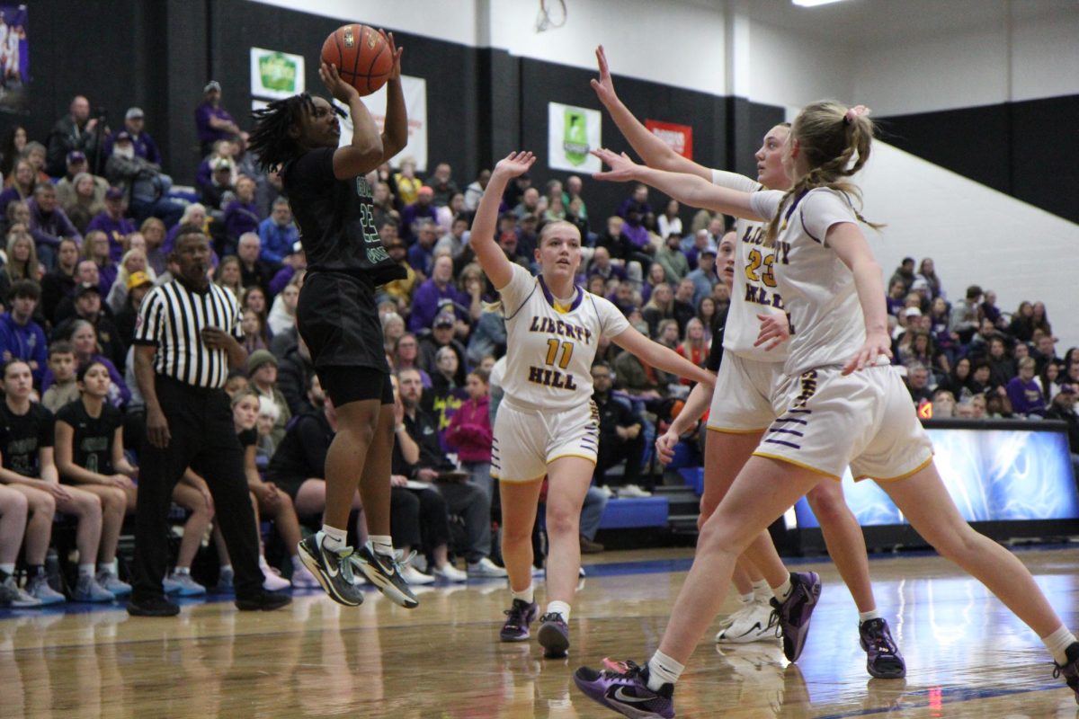 Three defenders try to stop senior point guard Hope Edwards before the ball leaves her hands. The girls basketball team faced Liberty Hill on Feb 21, losing 58-40. “[My season was] definitely bittersweet,” Edwards said. It's definitely sad [because] I'm gonna miss all my teammates, my coaches and just the whole CP environment.”