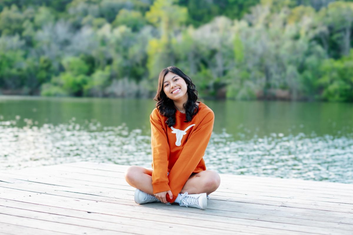 Sitting on a dock during her senior photo session, senior Kenzie Vo poses for the camera. Vo will attend the University of Texas at Austin next year and major in mechanical engineering after graduating as Valedictorian on May 23 at 2 p.m. at the HEB Center. “At the beginning, I wanted to be valedictorian just for the glory,” Vo said. “And then I realized that's not what's important. It's what you can give back to all those people who have given so much up for you. I have found fulfillment in that.” Photo by Natalie Cohen